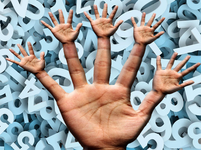 Hand with miniatue hand at the end of each finger over background of numbers